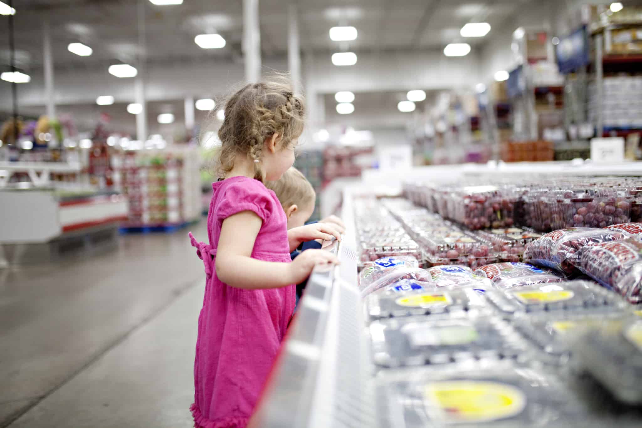 crianças a escolher fruta no supermercado
